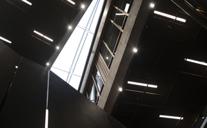 Exterior of a commercial distribution facility at dusk with LED lighting illuminating loading docks