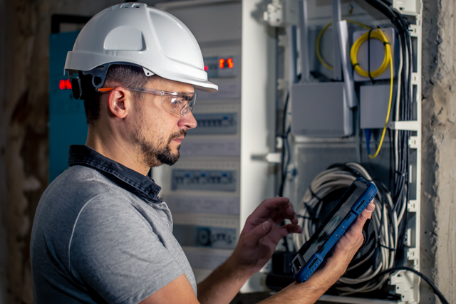 RGO Services technician inspecting an electrical panel
